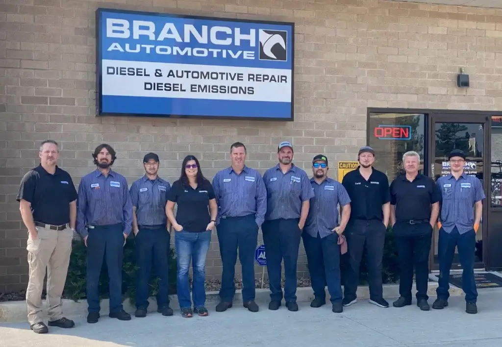 Welcome to Branch Automotive, the Best Diesel Repair in Littleton, CO. Image of the team at Branch Automotive, with signage at the background.