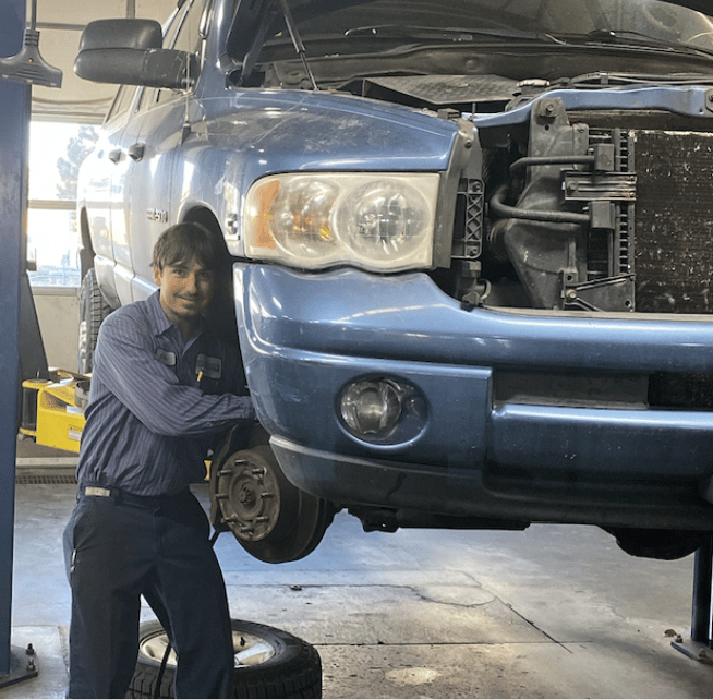 Image of a diesel mechanic working on a vehicle. Concept image of Branch Automotive's services, including brake repair, diesel emissions testing, and steering and suspension services.