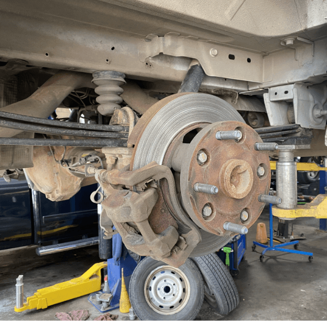 Closeup image of a brake rotor and caliper under brake repair at Branch Automotive.