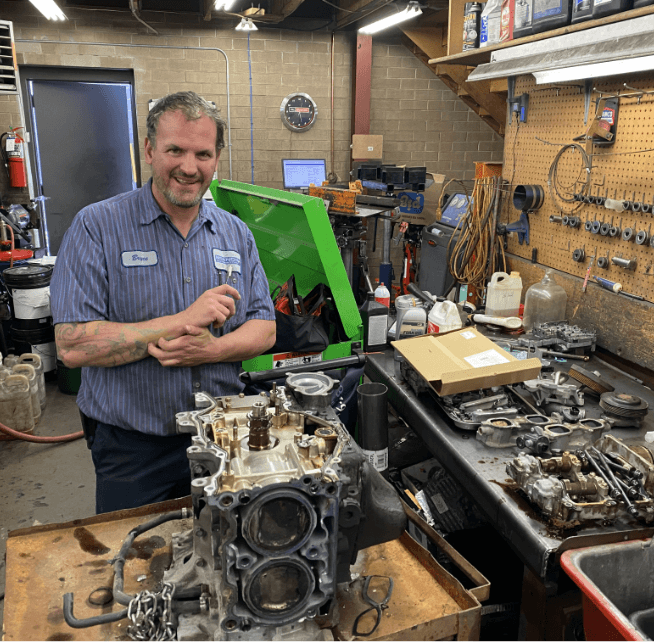Image of a Branch Automotive mechanic doing engine repair.