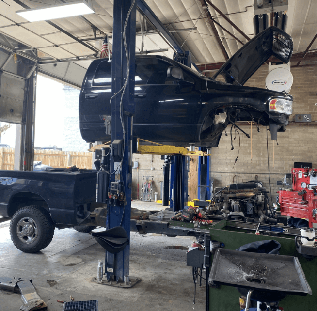 Image of a blue pickup truck taken apart for repairs. Concept image of Branch Automotive's services, including diesel services and transmission repair.