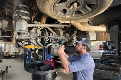 Expert Diesel Repair in Littleton, CO | Branch Automotive | ASE Certified Mechanics. Image of mechanic under diesel truck in for repairs at the shop taking image using DVI technology.