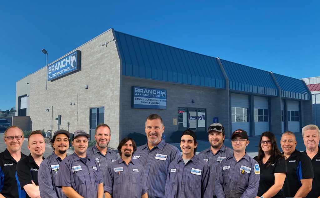 close up image of owner Parker Branch and employees posing outside of Branch Automotive