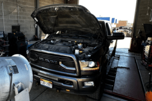 Diesel Truck Maintenance in Littleton and Highlands Ranch, CO with Branch Automotive. Image of a black Dodge Ram with its hood open, undergoing diesel truck maintenance services at Branch Automotive