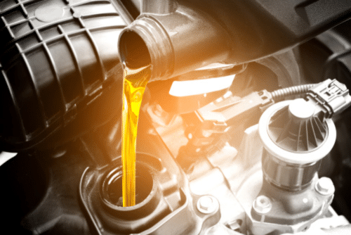 Diesel Engine Service in Littleton, CO by Branch Automotive. Image of refueling and pouring high-quality oil into a car engine as part of diesel engine maintenance.