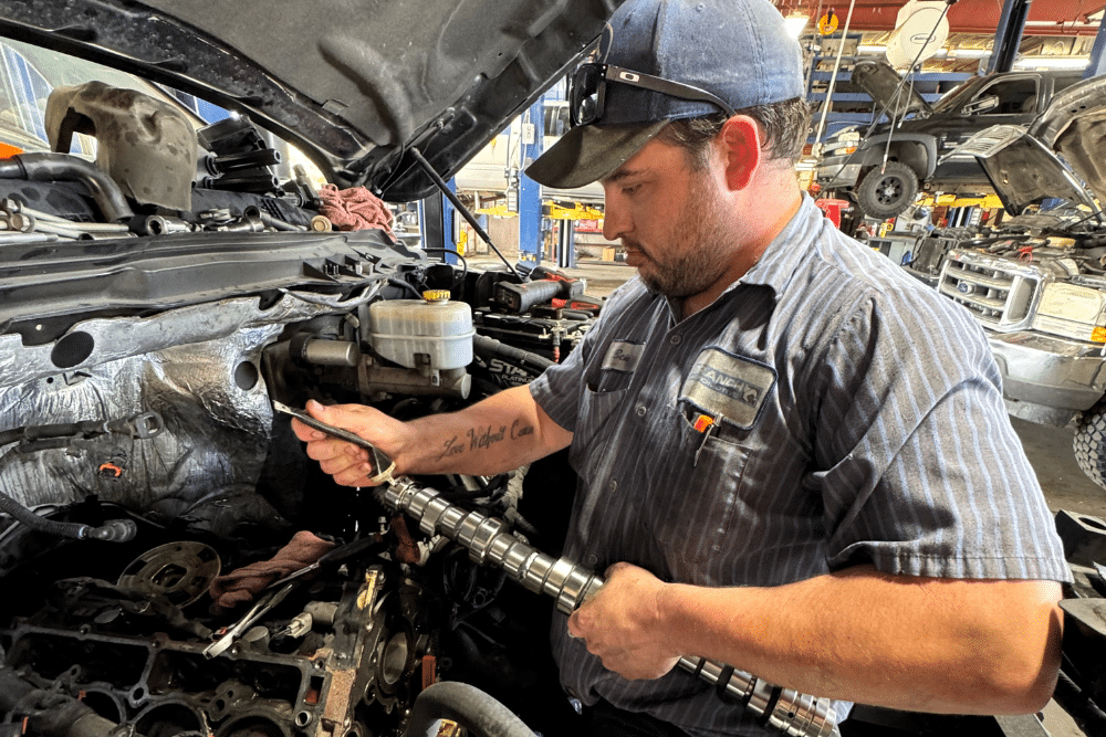 Camshaft Repair Services in Littleton, CO, 80122, by Branch Automotive. Image of a technician carefully examining the camshaft in a Dodge Ram 1500 engine, depicting the precise diagnosis and repair process necessary for optimal vehicle performance.