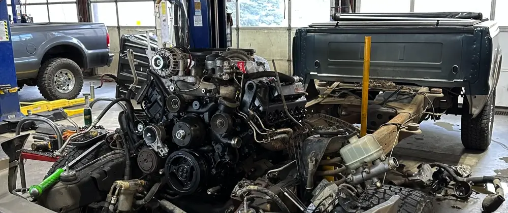 Ford truck timing chain maintenance and repair in Littleton, CO at Branch Automotive. Image of new ford truck engine and parts with timing chain replacement up close in shop.