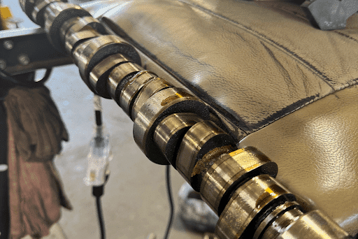 How can you tell if your car’s engine camshaft has failed in Littleton and Highlands Ranch, CO? With Branch Automotive. Close up image of a faulty camshaft out of a dodge 1500 in shop.