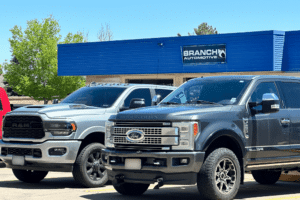 diesel repair specialists, diesel repair in Littleton, CO at Branch Automotive. Silver Chevrolet Silverado HD parked outdoors, showcasing its bold grille, chrome accents, and off-road tires.