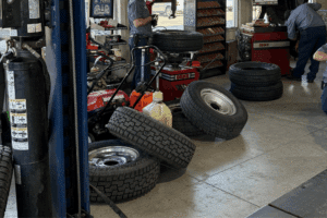 Multiple used tires scattered across the floor of the Branch Automotive auto repair shop in Littleton, CO, for tire safety and repairs.