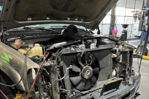 Diesel truck A/C repair in Littleton, CO by Branch Automotive. Image of a radiator and condenser removed from a diesel truck during a summer cooling system inspection.