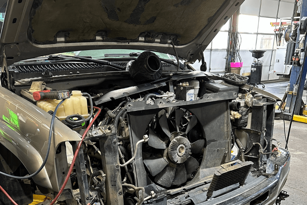 Diesel truck A/C repair in Littleton, CO by Branch Automotive. Image of a radiator and condenser removed from a diesel truck during a summer cooling system inspection.