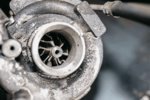 Turbocharger repair in Littleton, CO by Branch Automotive. Image of a worn and heat-damaged turbocharger showing the effects of poor maintenance.
