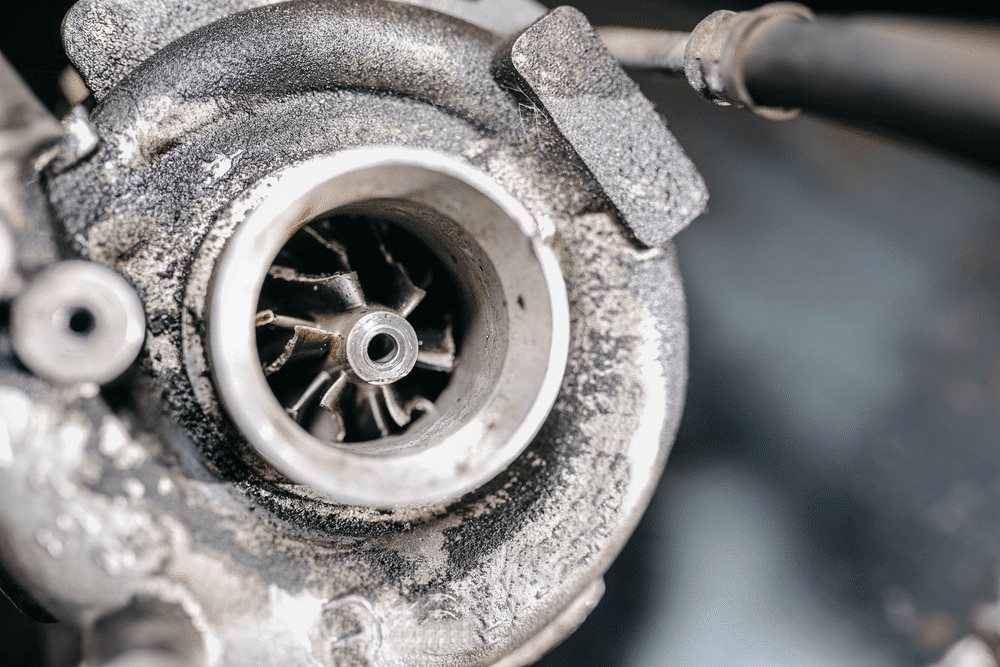 Turbocharger repair in Littleton, CO by Branch Automotive. Image of a worn and heat-damaged turbocharger showing the effects of poor maintenance.