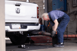 Diesel emissions testing in Littleton, CO by Branch Automotive. Image of a technician working on a white Ram 4x4 truck, highlighting the shop’s commitment to precise diagnostics, performance, and reliability for diesel truck owners.