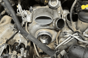 Diesel turbo repair in Littleton, CO by Branch Automotive. Image of a diesel engine turbocharger assembly during service, showcasing the shop’s expertise in boosting engine performance, reliability, and efficiency.