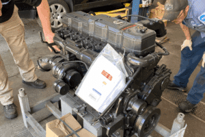 Diesel specialists, diesel repair in Littleton, CO by Branch Automotive. Image of technicians inspecting a Cummins turbo diesel engine, highlighting precision diagnostics, heavy-duty repair, and specialized maintenance for diesel trucks.
